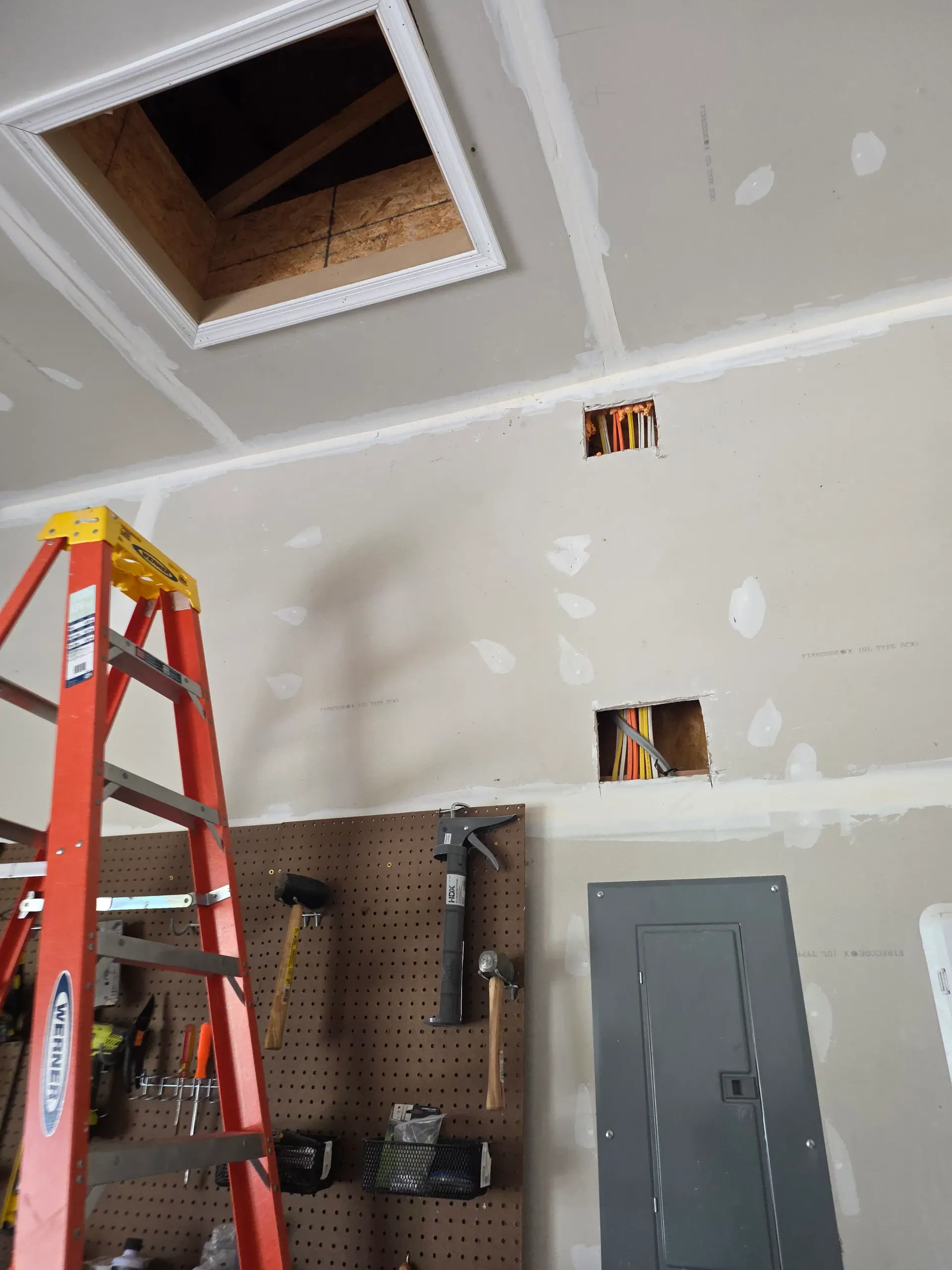 Residential electrical wiring in progress through a wall before finished surfaces are closed