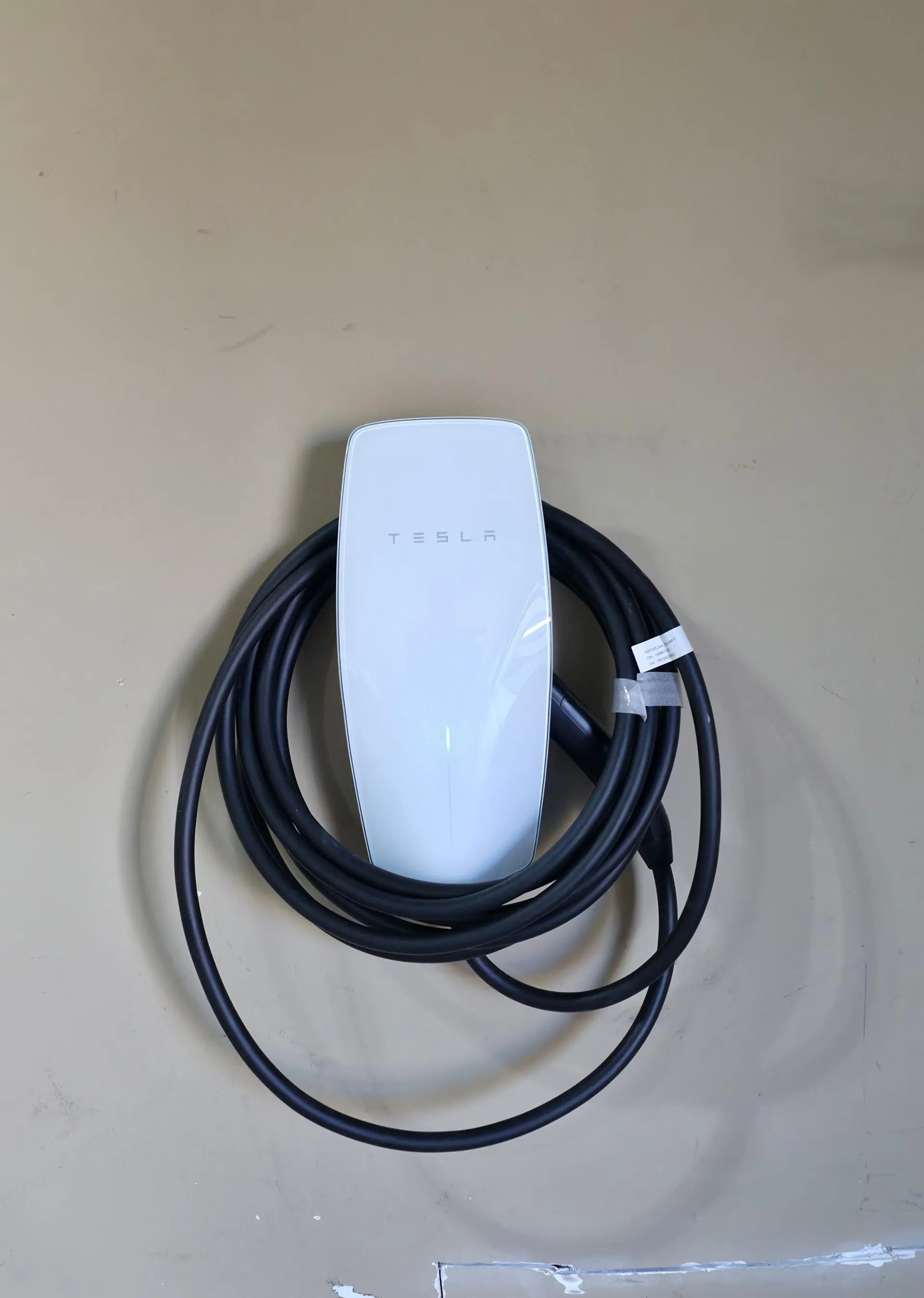 Tesla Wall Connector installed on a residential garage wall